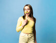 © VISTA by Westend61 - Woman holding a yellow paper mustache on a stick against a blue background