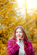 © Vantsura - Young person poses outdoors in autumn with trees in the background during golden hour light