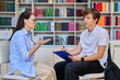© Valerii Honcharuk - Middle-aged female counselor talking to a teenage boy with a clipboard