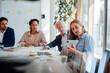 © BusinessClass by W61 - Business colleagues discuss architectural blueprints on a tablet