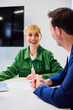 © BusinessClass by W61 - Smiling businesswoman and colleague discuss document at the office