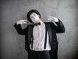 © Nomad_Soul - Mime performer tilting his head and pointing down with both hands