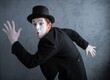 © Nomad_Soul - Funny mime actor in dynamic running pose with an astonished expression