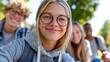 © Nataliya - Young adults taking a selfie during an outdoor educational workshop, diverse group, learning experience, teamwork, community, social media, professional development, outdoor