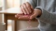 © Jonathan - Close up on hands holding and spilling pink pills representing medication health and treatment Lifestyle care and well being concept