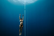 © Akela - from alp to alp/Stocksy - freediver training on a line in open blue water