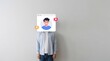 © Viktor - Man stands against plain wall with digital user profile icon over head. Virtual avatar represents online identity, social media account. Concept of internet privacy, anonymity, communication in