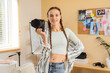 © Pixel-Shot - Creative career and photography hobby, young woman holding professional camera in home studio with mood board and lighting equipment for content creation