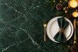 © Yumona - Elegant Christmas table setting with plate, napkin, and glowing candles on green marble with copy space