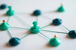 © Keopaserth - Network connection concept connected pins teal pushpin white background teamwork communication social network node link connection