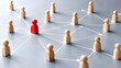 © Arfan - Red wooden peg figure connected by white lines to a network of plain figures on a grey background illustrating networking, leadership, teamwork and business organization structure