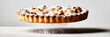 © serz72 - A pie with flaky dough sits on a flat surface. It has layers of fruit filling and is dusted with powdered sugar. The scene shows the pie in an everyday kitchen environment.