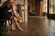 © Petr - Dancer Preparing Shoes in Studio with Wide Copy Space