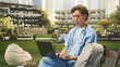 © DC Studio - Male medical student studies independently on a laptop from a campus bench, working through med-school material as an international student.