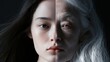 © Daria - Portrait split down the middle showing youthful skin on one side and aged, wrinkled skin with white hair on the other illustrating the contrast of aging and tim