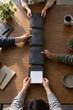 © Image Tree - Team passing document folders along a shared table
