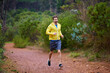 © peopleimages.com - Man, runner and jog in forest for fitness exercise, training and workout on park trail. Winter, nature and healthy athlete running in woods for practice for wellness, endurance and outdoor sports