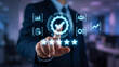 © Rizky Wardhana - Businessman touching virtual screen with digital quality assurance icons