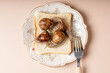 © Cavan Images - Four live snails crawling on a piece of bread on a plate