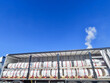 © Maxim - Two rows of wrapped rolls fill an open truck trailer beneath a blue sky, freight logistics, bulk shipping, delivery preparation.