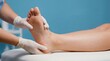 © Rimsha - Foot reflexology massage being performed by a therapist wearing medical gloves on a patient lying down in a clinic room.
