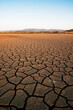 © Cosma Andrei/Stocksy - Climate change consequences with dried lake at sunset
