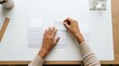 © obak - Hands Meticulously Organizing and Sorting Stacks of White Documents on a Clean Desk for Enhanced Administrative Workflow and Productivity