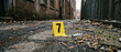© Krug - Crime Scene Evidence Marker and Syringe in Grimy Urban Alleyway
