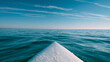 © MDRAFIQUL - White surfboard nose floating on blue ocean waves under a clear sky with wispy clouds, perfect for surfing adventures.