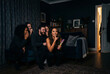 © Leo Rohmann - Friends react during a spooky movie night at home