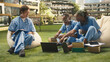 © DC Studio - Medical students smiling and exchanging ideas with laptop and coursework notes during relaxed outdoor group study session on modern university campus, supporting a medical training program.