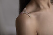 © Metadancer - Close-up of shoulder with flower petals on smooth skin