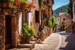 © nsit0108 - Valldemossa village street in mallorca, spain, showing traditional stone buildings, blooming colorful flowers, green plants, and a charming narrow cobblestone alley during summer