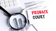 © Iryna - Probate court text on lined paper with magnifier, calculator, pen and charts, legal estate administration and inheritance concept
