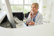 © Pixel-Shot - Healthcare administration and patient support, medical receptionist talking on phone at hospital front desk with computer and clinical office background
