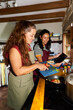 © Alvaro Lavin/Stocksy - Women cooking vegetables in kitchen following online recipe