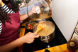 © Alvaro Lavin/Stocksy - Woman cooking pasta on stove for dinner meal