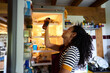 © Alvaro Lavin/Stocksy - Woman searching for food in open refrigerator at home