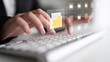 © InfiniteFlow - A close-up view of hands typing on a keyboard with digital representations of folders and files, symbolizing organization and data management in a contemporary office environment. Cyphers
