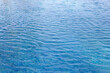 © Bowonpat - Clear blue swimming pool water background with gentle ripples.