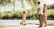 © BGStock72 - Family enjoying a sunny day by the lakeside with laughter and joy