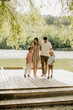 © BGStock72 - Enjoying a family stroll by the tranquil lakeside on a sunny afternoon