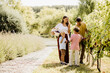 © BGStock72 - Harvesting grapes with family in a sunny vineyard during autumn
