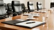 © Panuwat - Polished conference table with an open folder, pen, and coffee cups in a boardroom.