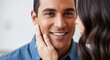 © Assets - Close up portrait of a smiling man with a woman touching his cheek