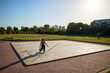 © Javier Díez/Stocksy - Surfskater performs tricks on empty concrete pad in park