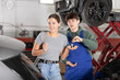 © JackF - Happy girl happy with her car being repaired. Auto mechanic give her the car keys