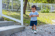 © leungchopan - Little asian boy walking on gravel path in outdoor park