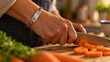 © Teeradej - Close-up of a wrist wearing a simple metal medical ID bracelet with an engraved plate, the hand chopping carrots on a board. Living with epilepsy day to day concept.