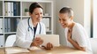 © TheseusStock - Doctor sharing good news on tablet with happy cancer patient in office